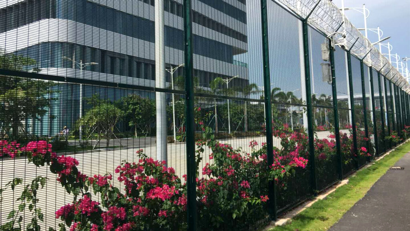 High-security perimeter integrating welded mesh, posts, connections, foundations and security topping