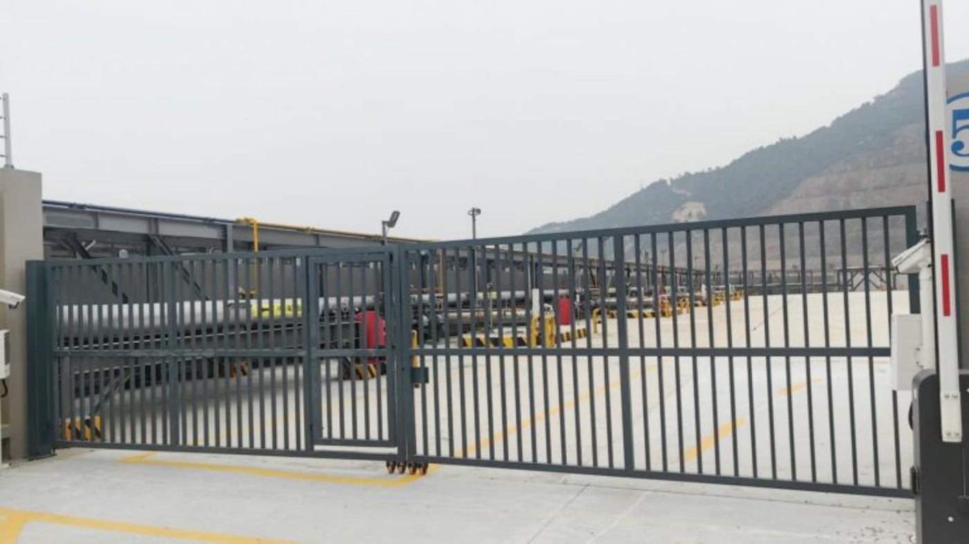 Industrial double-leaf swing gate at vehicle entrance