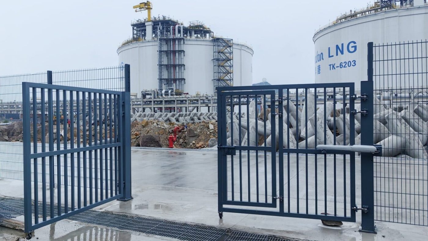 Pedestrian gate integrated with perimeter fence in LNG plant