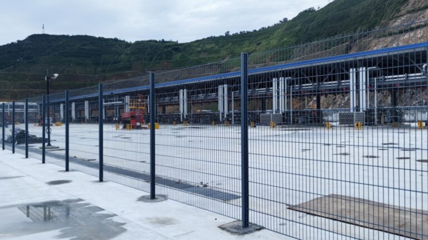 Straight welded mesh fence line inside LNG industrial facility