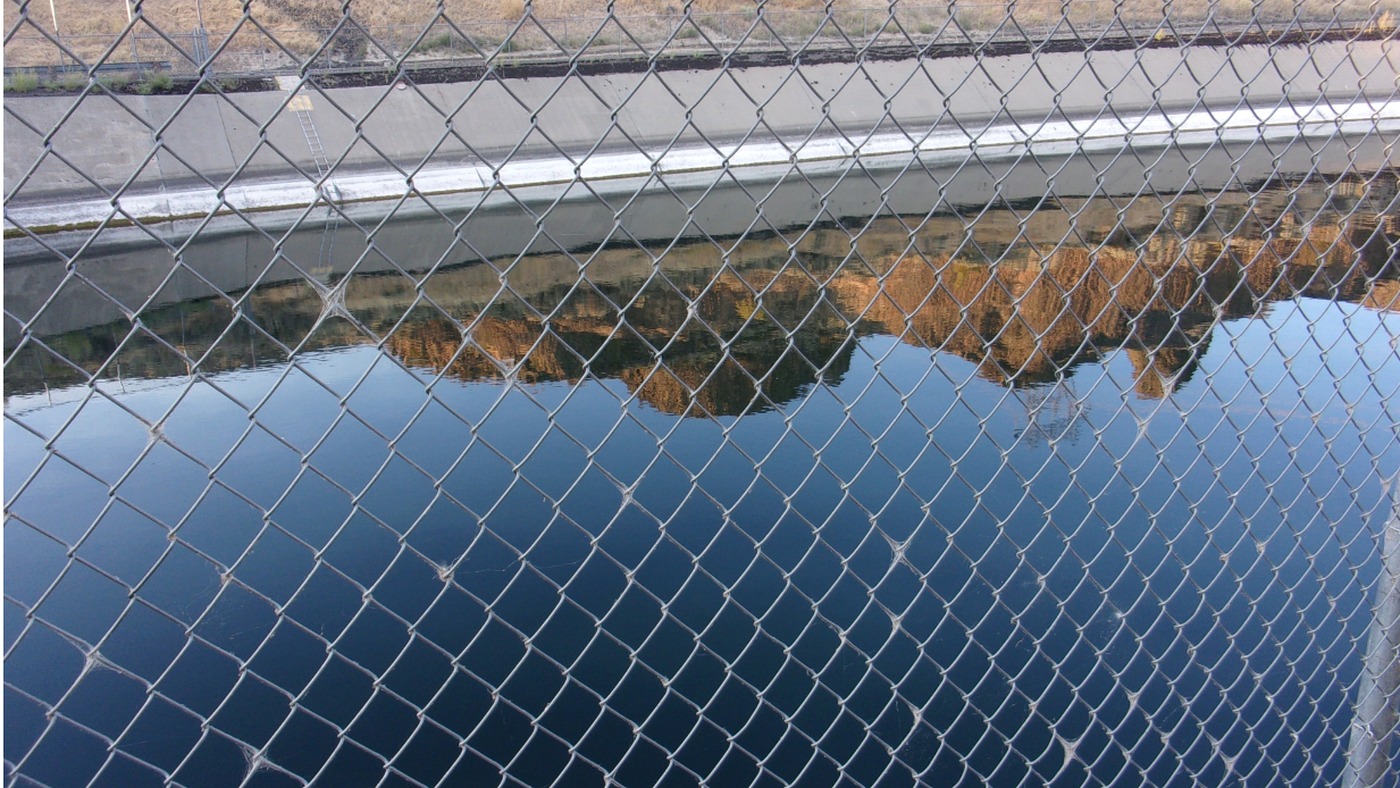 Perimeter fence around a hydropower water-control channel