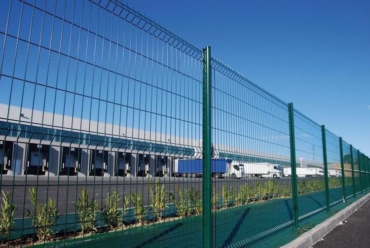 Long 3D welded mesh fence aligned with logistics buildings