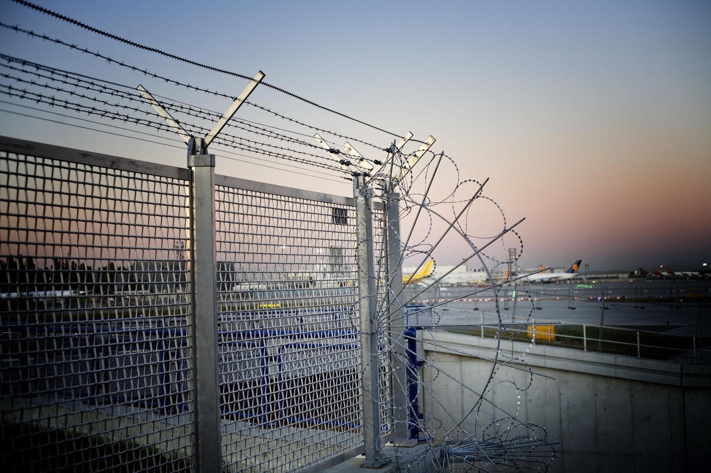High-security airport perimeter fence with anti-climb mesh and top protection