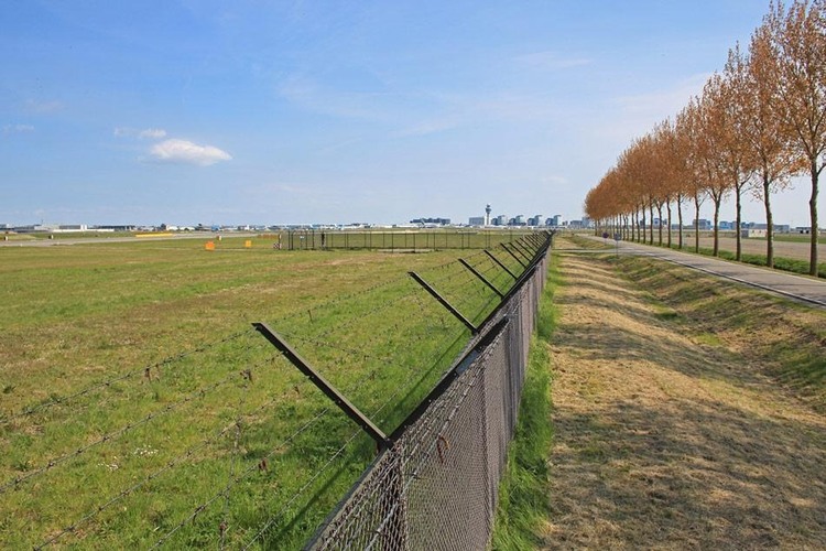Long-distance airport perimeter fence across open terrain