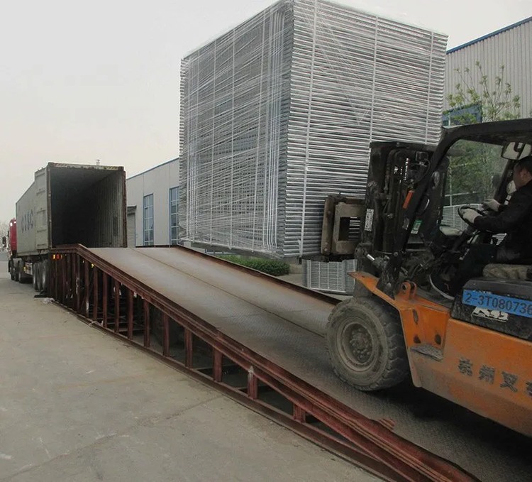 Galvanized fence panels being loaded for shipment