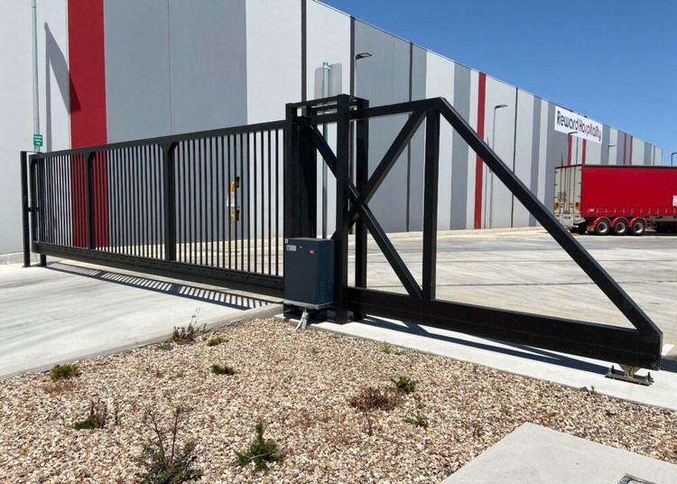 Cantilever vehicle gate at an industrial entrance