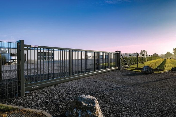 Long welded mesh fence line with a vehicle gate