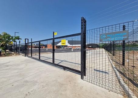 Vehicle entrance gate combined with perimeter fence