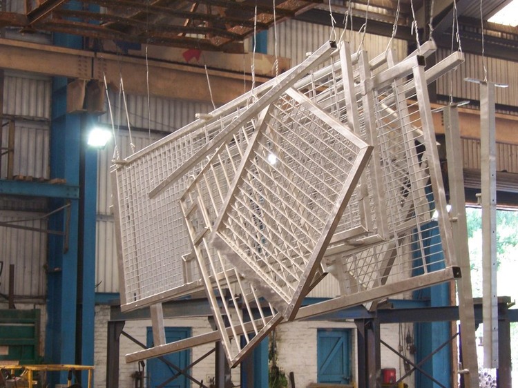 Galvanized fence panels and steel frames in a factory production environment